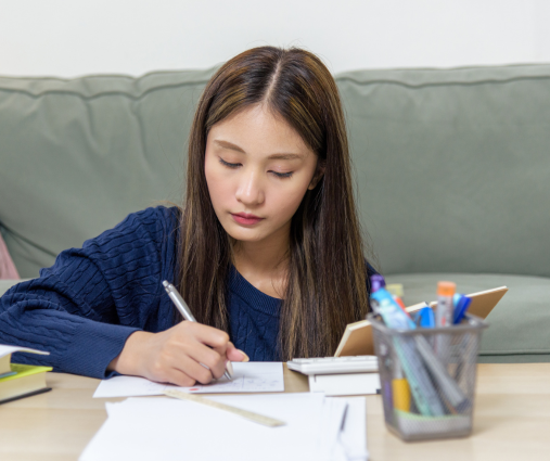 Teen girl calmly studying for her GCSE exams at home